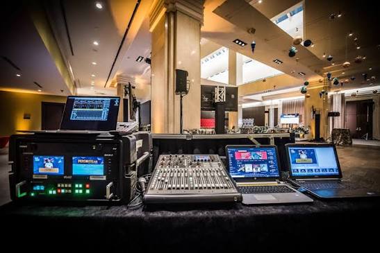 Audio mixing desk and playback equipment at an indoor event